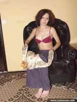 Teen brunette takes off pants and poses nude