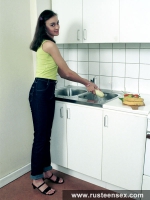 Teen brunette masturbates in the kitchen