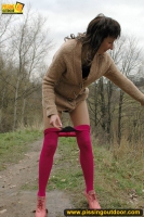 Mom pisses outdoor on the road