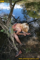 Teen blonde pissing in the lake