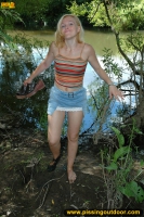 Teen blonde pissing in the lake