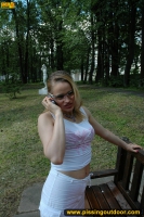 Teen blonde pissing on the park bench
