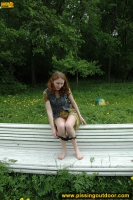 Pissing outdoor on a park bench