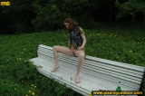 Pissing outdoor on a park bench
