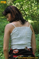 Teen brunette pissing outdoor in the forest