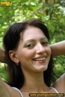 Teen brunette pissing outdoor in the forest