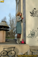 MILF blonde pissing outdoot on the painted pedestal