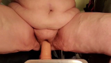 Brandy riding her toy.Front view