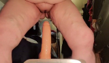 Brandy riding her toy.Front view