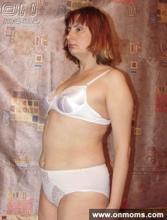 Mature blonde undresses and poses - N