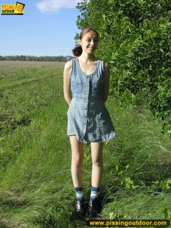 Pissing outdoor on a green grass - N