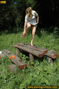 Pissing outdoor deep in the forest on the old table - N