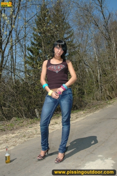 Teen brunette pissing on asphalt path outdoor - N