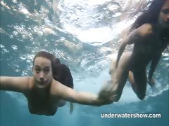 Julia and Masha are swimming nude in the sea